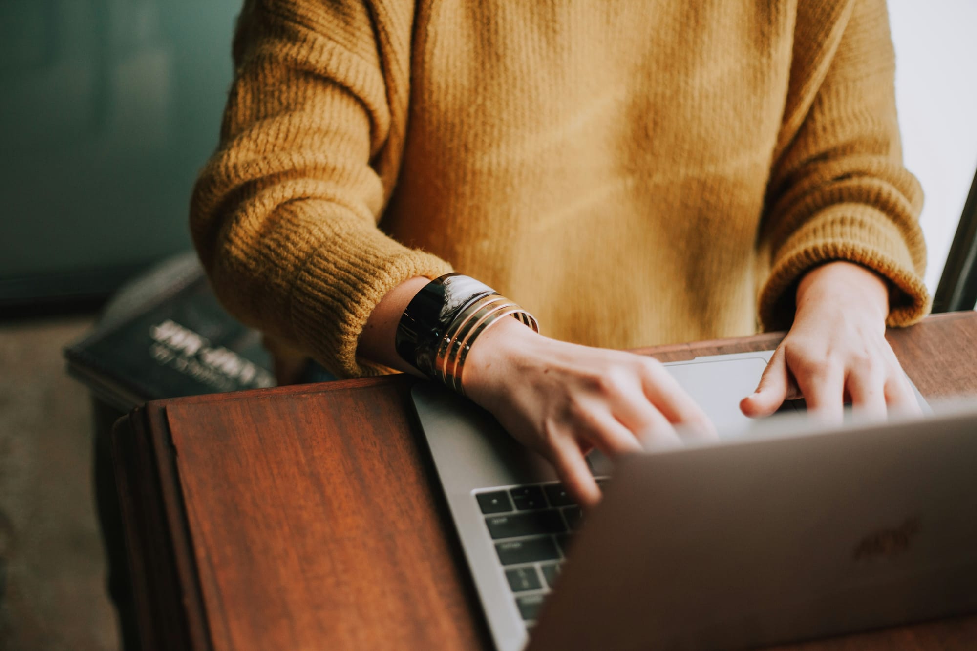 person typing on laptop - Best AI Writing Assistant