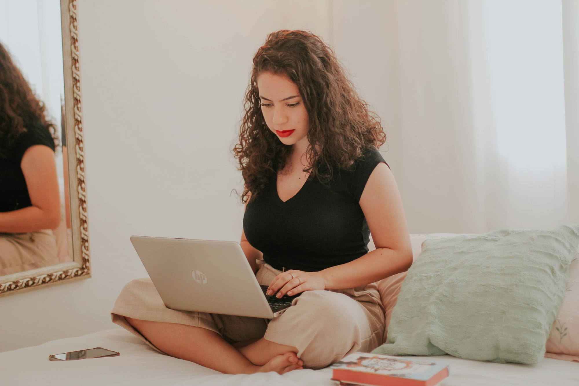 woman on her bed using AI - What Is AI Writing