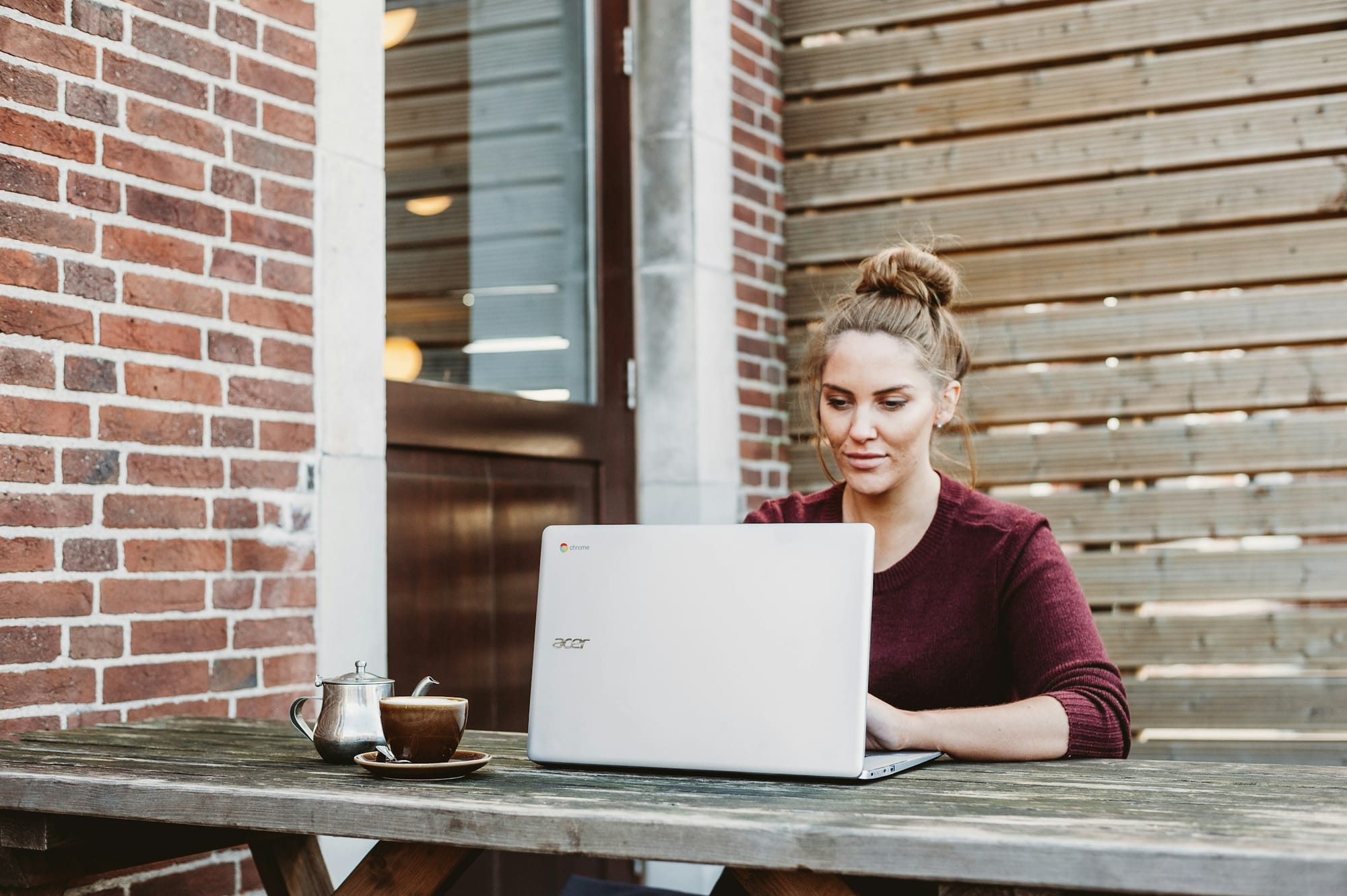 woman sitting infront of laptop - SEO Content Writing Software