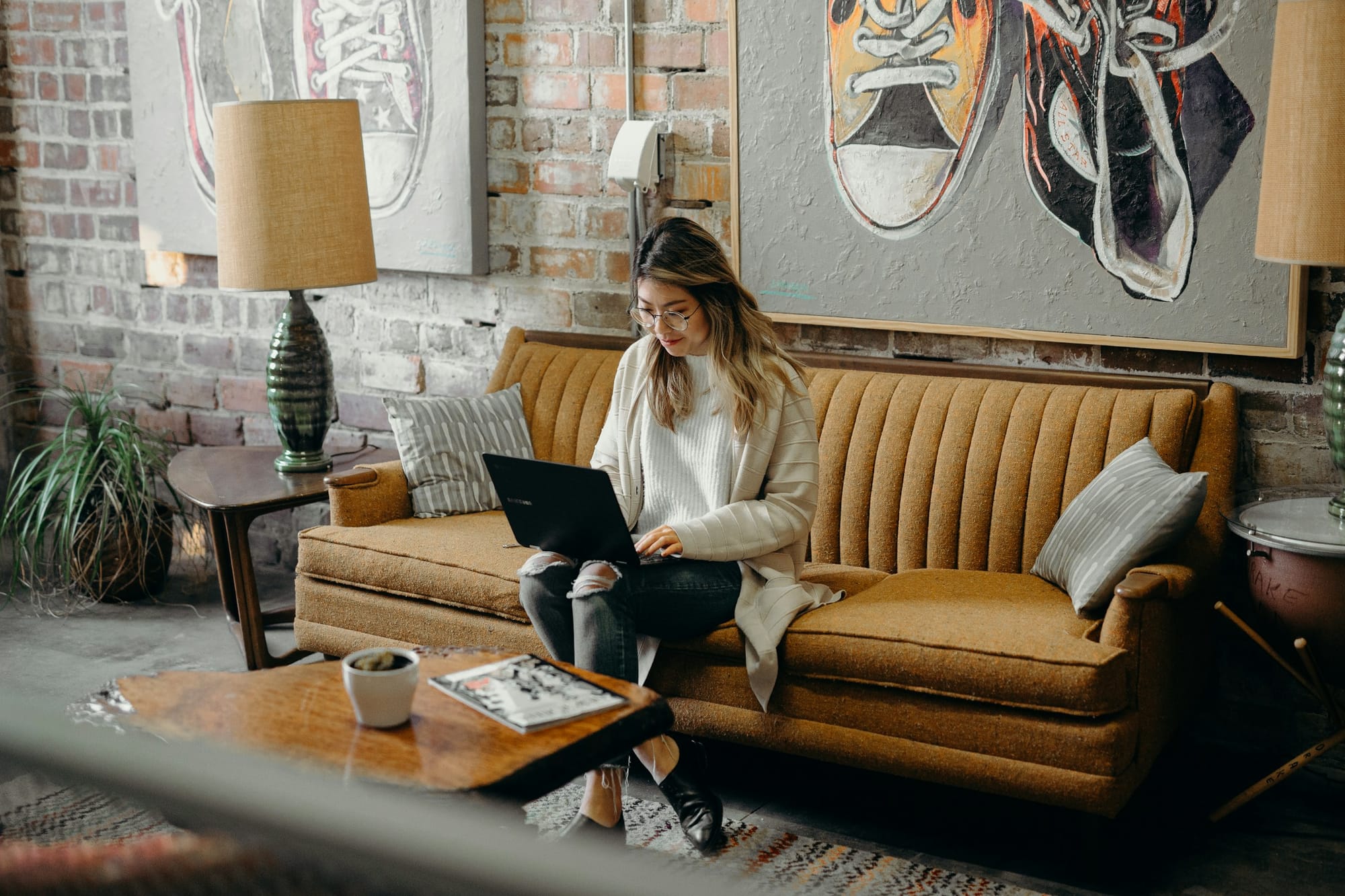 woman with laptop on lap - SEO Content Writing Software