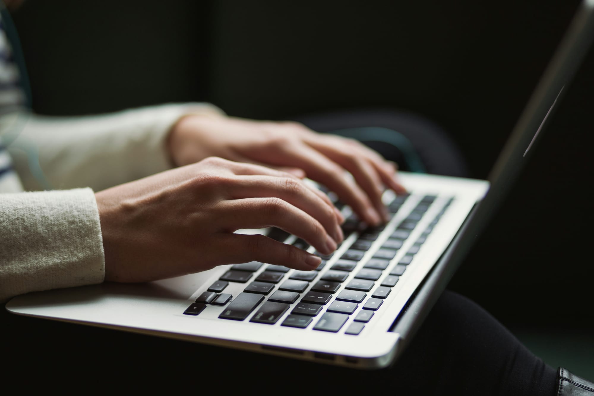 woman typing on laptop - AI Writing Tools