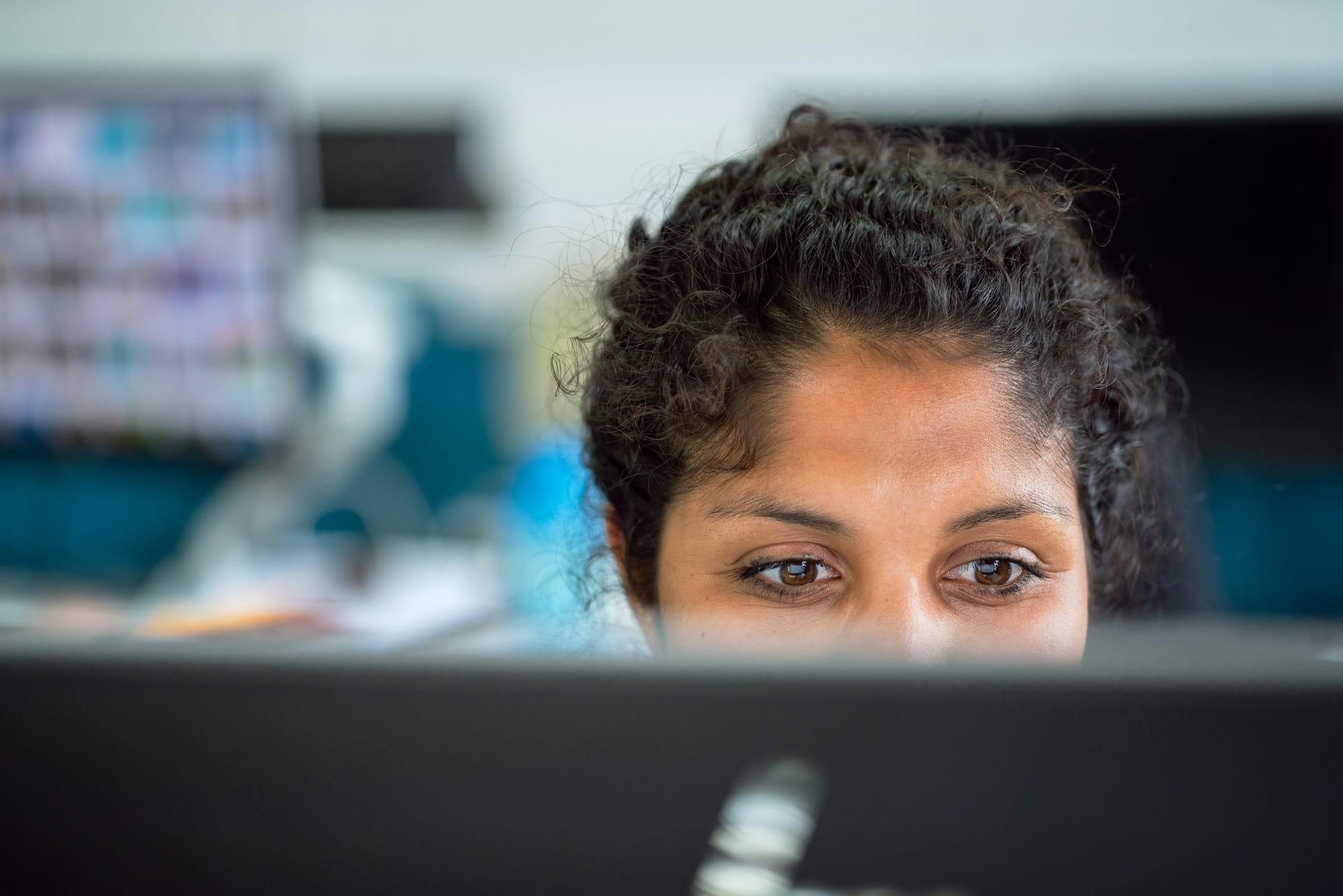 woman sitting in front of computer - How to Repurpose Blog Content for Social Media