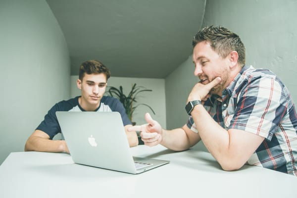 man helping junior with AI Content Strategy